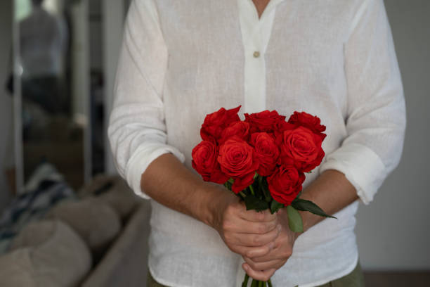 istock Man holding a bunch of roses 1982158206