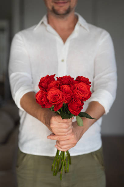 istock Man holding a bunch of roses 1982158211
