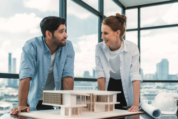istock Smart architect engineer team working together to measure house model. Tracery. 1982160292