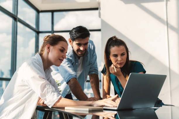 istock Group of profession business people pointing at laptop displayed idea. Tracery. 1982166201