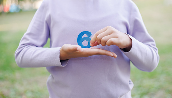 Child Holding Number 6