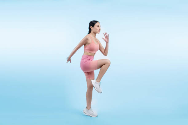 istock Side view young athletic asian woman on running posture. Vigorous 1982219817
