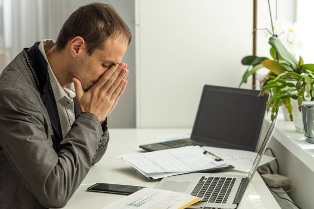 istock business, people, fail, paperwork and technology concept - businessman with laptop computer and papers working in office 1982223991