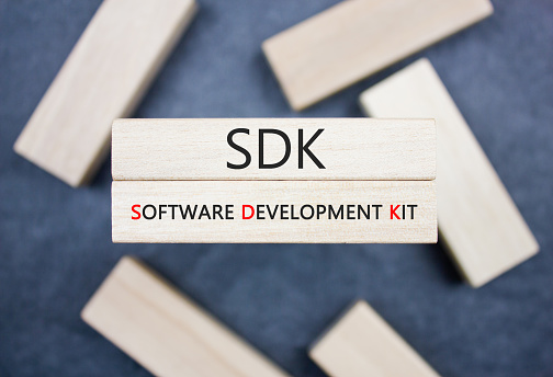 SDK. Software Development Kit text, acronym on wooden block. SDK concept.