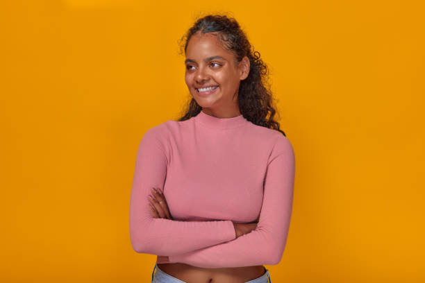 istock Young confident Indian woman posing with arms crossed and looking to side 1982249380