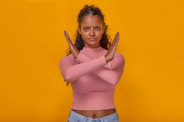 istock Young angry Indian woman demonstrates prohibiting gesture stands in studio 1982249893