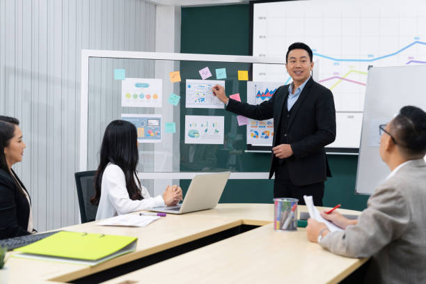 istock Businessmen present financial project for managers' approval. Intellectual. 1982252053