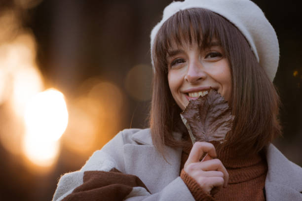 Portrait of young lady at public park in autumn.