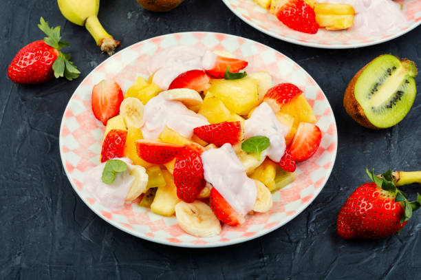 istock Fruit juicy salad with yogurt on a plate. 1982281020