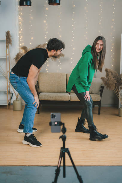 istock Couple recording videos for their blog learning moves with online classes and tutorials. Dance challenge concept. Young man and woman 1982300601