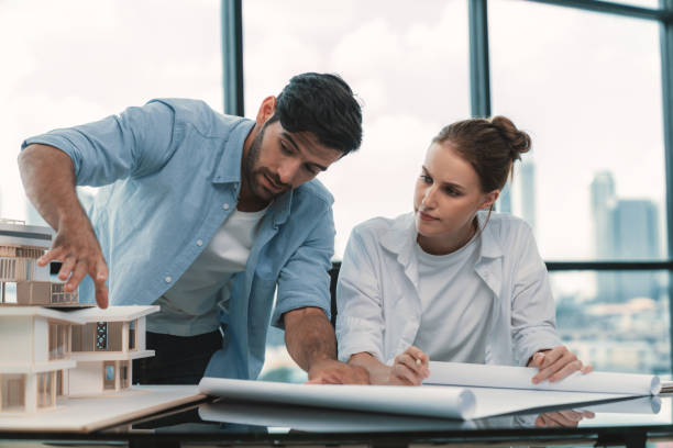 istock Professional architect team working together to design house model. Tracery. 1982302219