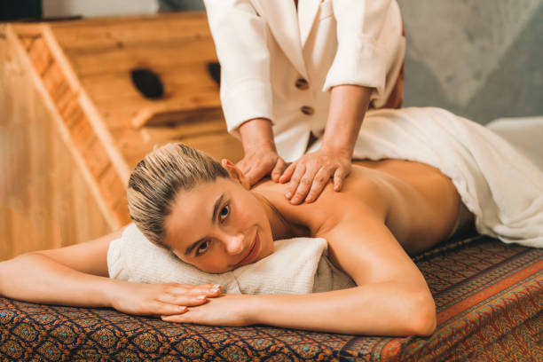 istock A pretty girl having a massage while looking at camera at sauna. Tranquility. 1982311269