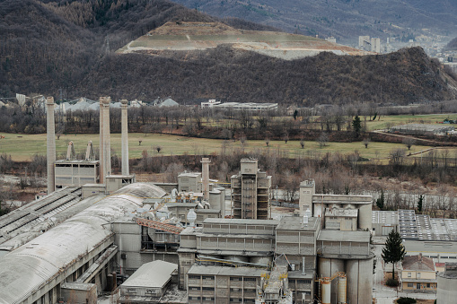 Cuneo (Piedmont), Italy. February 1, 2024.  Panorama of an industrial production area at the foot of the Maritime Alps (Borgo San Dalmazzo, Piedmont, Italy)