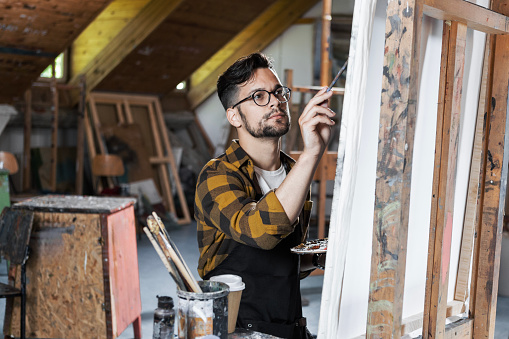 Young painter in his art studio