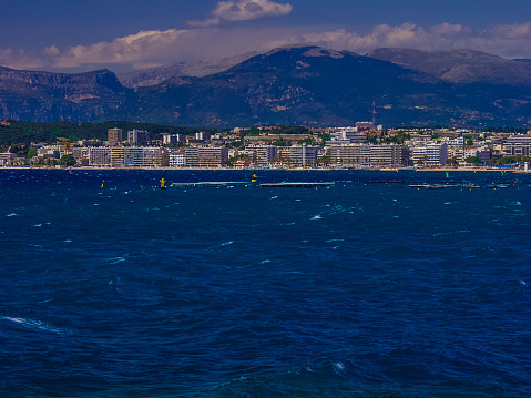 The chic resort of Juan-les-Pins is known for its long, sandy beaches and seafront promenade lined with smart outdoor eateries and fashion boutiques, overlooked by modern apartment buildings. Alpes Maritime Côte d'Azur Provence South of France.