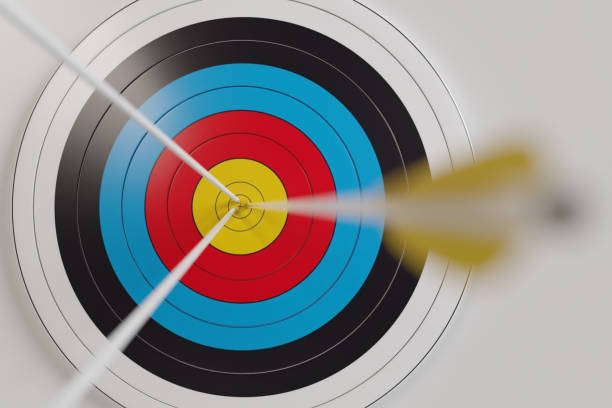 Archery target with arrows in the center on white background, Arrows hitting target