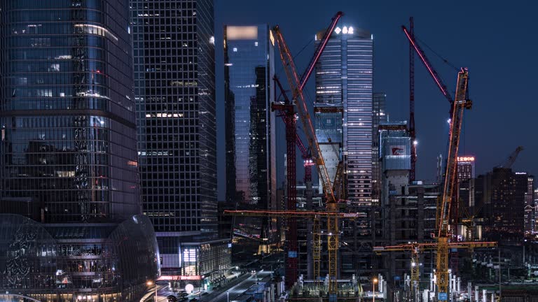 T/L Aerial View of Working in Construction Site in Central City, from Day to Night