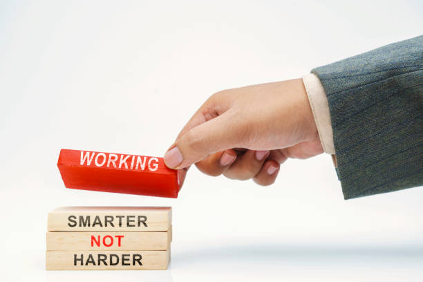 istock Business hand put wooden block stack Working Smarter Not Harder text 1982394306