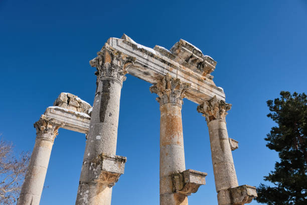 Ceremonial Gate (Pillars) at Uzuncaburc (Diocaesarea) , Mersin - Turkey Low Angle Shot Of Ceremonial Gate (Pillars) at Uzuncaburc (Diocaesarea) , Mersin - Turkey uzuncaburc stock pictures, royalty-free photos & images