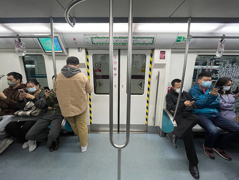 2022.10.26. Beijing, China. Passengers in the Beijing Subway Carriage.