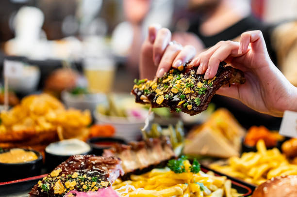 istock woman eating bbq pork ribs 1982455438
