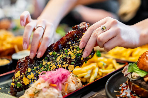istock woman eating bbq pork ribs 1982455440