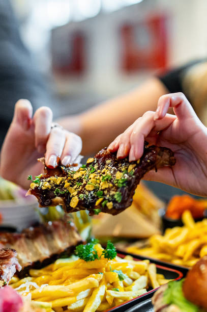istock woman eating bbq pork ribs 1982455445