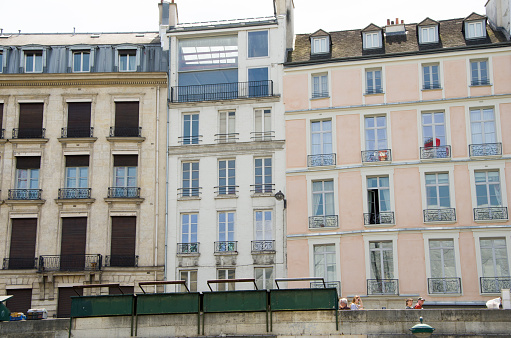 Travel in summer on a river boat along the Seine River in the center of Paris and see the sights, buildings and bridges