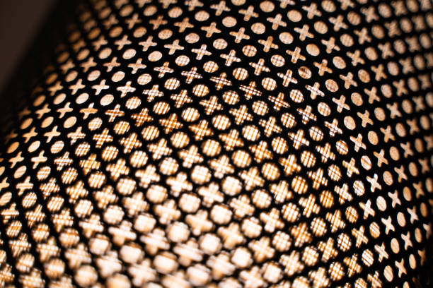 Light from woven wooden lanterns at night.