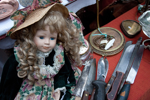 Creepy doll with knives.  Taken at a flea market in Argentina