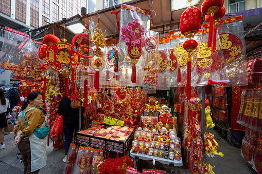 Hong Kong - February 3, 2024 : People select new year decorations at street market ahead of Chinese New Year in Hong Kong.