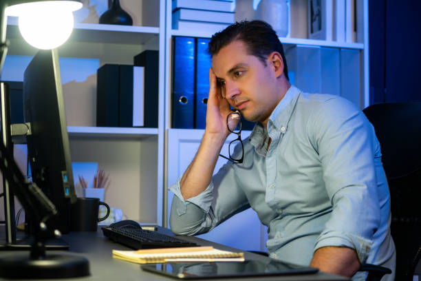istock Working businessman sleepy feeling with project at night time. Sellable. 1982472803