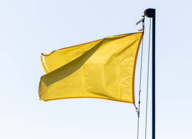 istock Yellow flag against a blue sky 1982477929