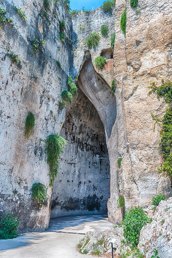 Entrance of the cave named Ear of Dionysius, one of the main landmarks in Neapolis Archaeological Park,  Syracuse, Sicily, Italy