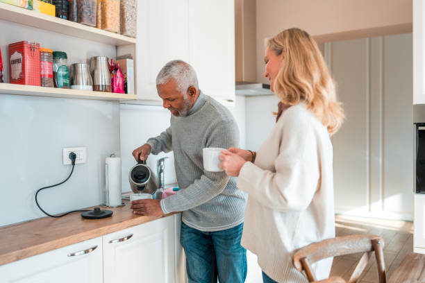 istock Diverse Senior Couple Preparing Coffee in Kitchen 1982512116