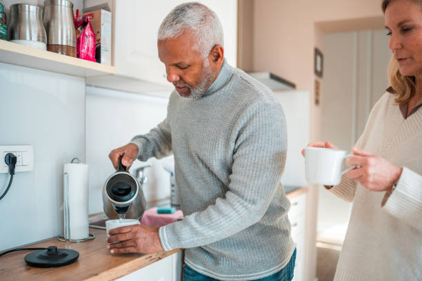 istock Diverse Senior Couple Making Coffee at Home 1982512671