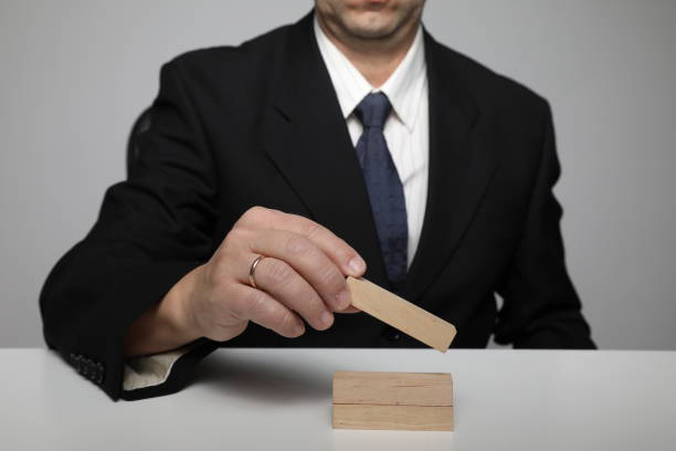 Businessman building blocks risk growth change insurance