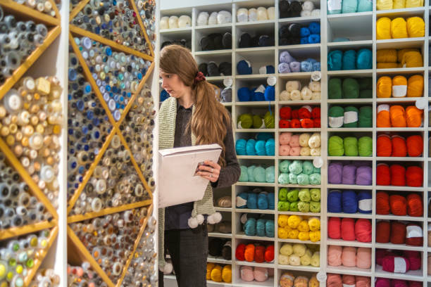 istock Cloth merchant choosing the material for her customer 1982529932