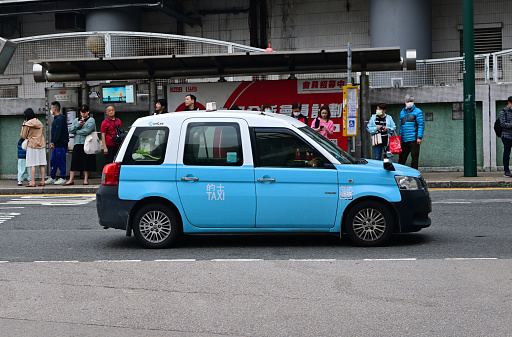 Light blue Taxi in Tung Chung, Lantau Island, Hong Kong - 02/03/2024 17:21:21 +0000.