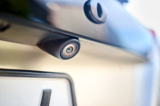 istock Luxury car rear view camera for parking assistance selective focus close up with sunflare and copyspace. Concept of safety car driving while parking process. Assist device equipment in modern cars. 1982533638