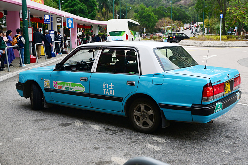 Light blue Taxi in Tung Chung, Lantau Island, Hong Kong - 02/03/2024 17:21:21 +0000.