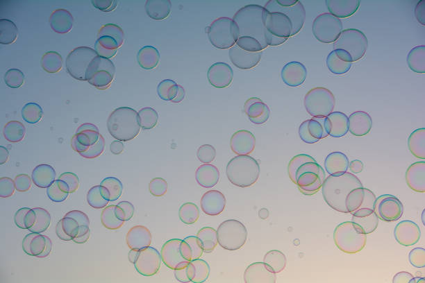 Many colorful soap bubbles float in the sky