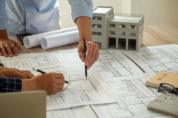 istock Professional cartographers working with cadastral map at table, closeup 1982543903