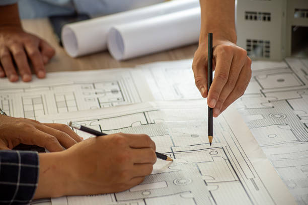 istock Professional cartographers working with cadastral map at table, closeup 1982543904