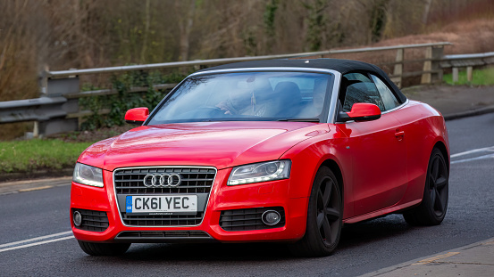 Milton Keynes,UK-Feb 3rd 2024: 2011 red Audi A5  car  driving on an English road.