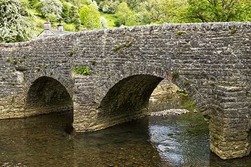 Bridge over the River Manifold at Wetton Mill, near Ashbourne, Derbyshire, England, UK - This bridge is on the Manifold Track (aka Manifold Way), a favourite trail for walkers, cyclists and horse riders. It is on the old route of the disused Leek and Manifold Light Railway.
