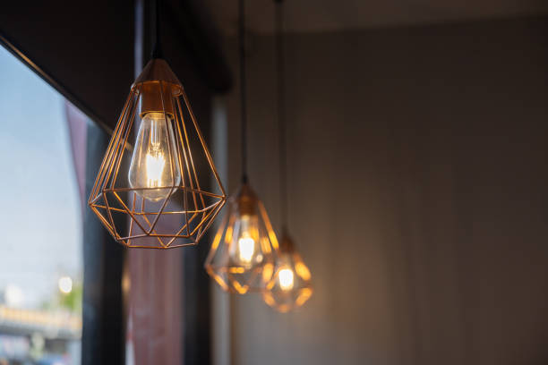 istock vintage light bulb hanging from ceiling for decoration in living room 1982584657