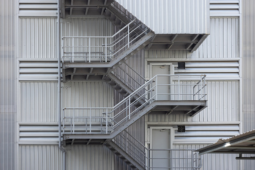 Side view of metal stairs and blue sky.