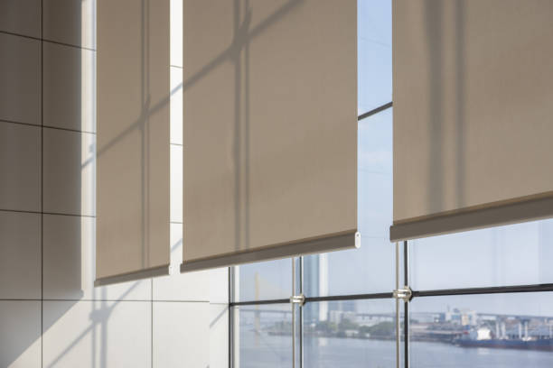 istock white curtain or white blinds Roller sun protection in office with river view background. 1982584664