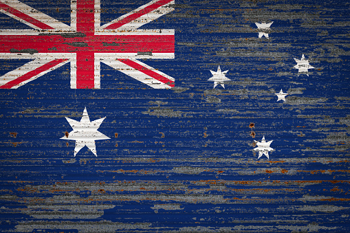 Close-up of old metal wall with national flag of Australia . Concept of Australia  export-import, storage of goods and national delivery of goods. Flag in grunge style